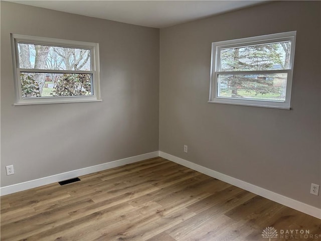 spare room featuring light hardwood / wood-style flooring