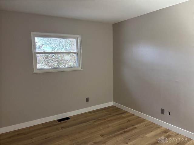 unfurnished room featuring wood-type flooring