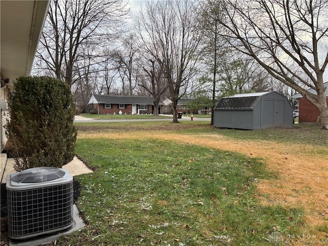 view of yard featuring a storage shed and central air condition unit