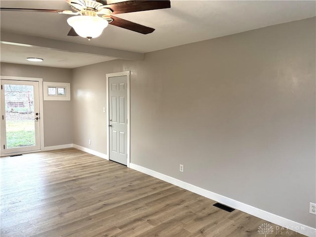 empty room with hardwood / wood-style floors and ceiling fan