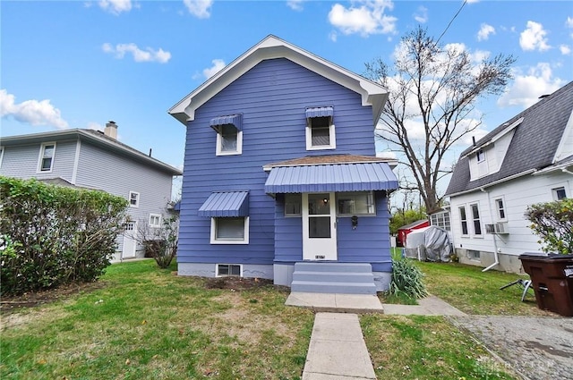 view of front of home with cooling unit and a front yard