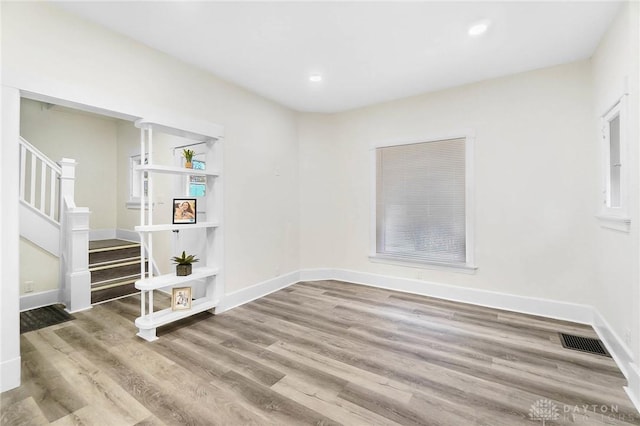 empty room with hardwood / wood-style floors