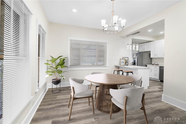 dining room with a chandelier and dark hardwood / wood-style flooring