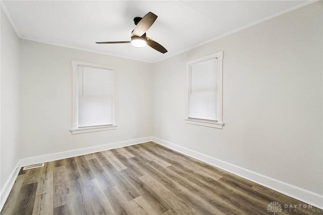 unfurnished room featuring hardwood / wood-style flooring, ceiling fan, and ornamental molding