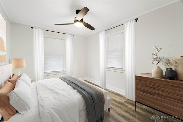 bedroom featuring ceiling fan, wood-type flooring, and crown molding