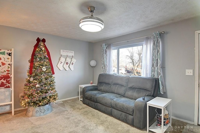 carpeted living room featuring a textured ceiling