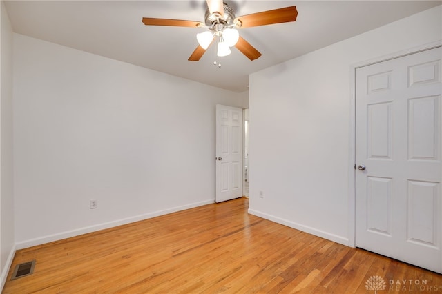 empty room with ceiling fan and light hardwood / wood-style floors