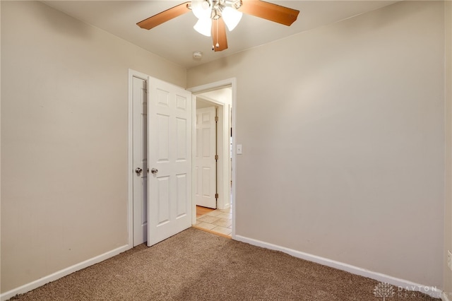 spare room with light carpet and ceiling fan