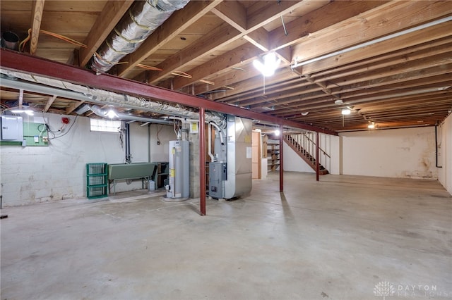 basement with electric panel, sink, heating unit, and gas water heater