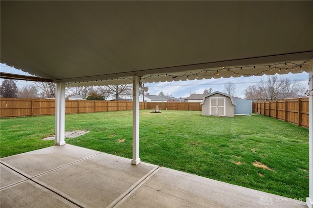 view of yard with a storage unit and a patio area