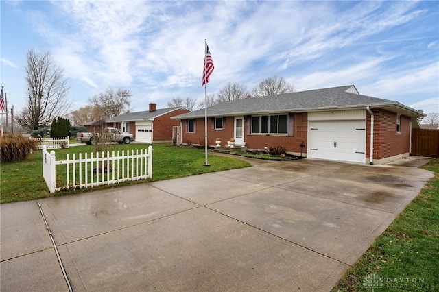 single story home featuring a garage and a front lawn