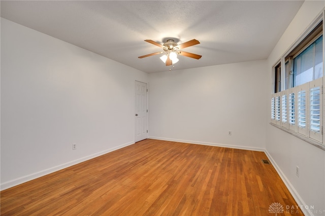 empty room featuring wood-type flooring and ceiling fan