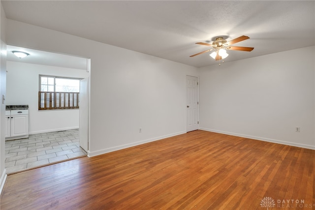 unfurnished room with ceiling fan and light hardwood / wood-style flooring