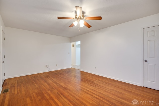 empty room featuring hardwood / wood-style floors and ceiling fan