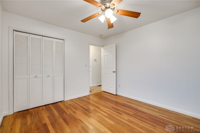 unfurnished bedroom with ceiling fan, a closet, and light hardwood / wood-style flooring