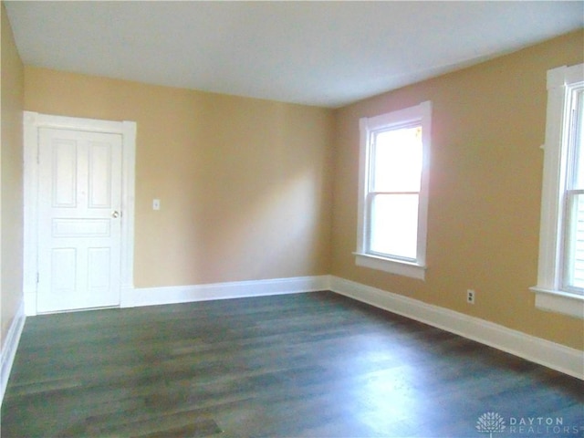 unfurnished room with dark hardwood / wood-style floors