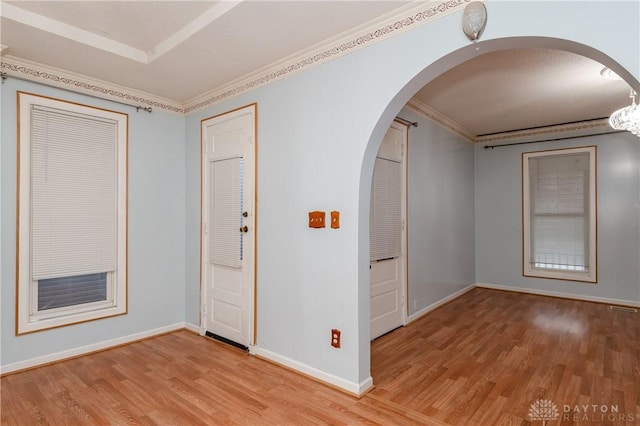 spare room with crown molding and light hardwood / wood-style floors