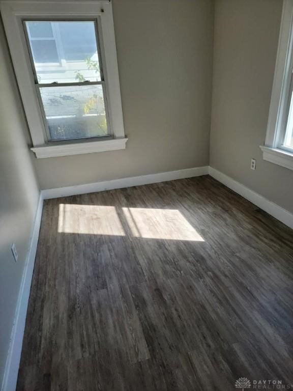 spare room featuring dark wood-type flooring