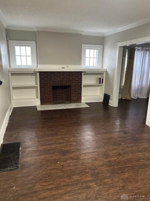 unfurnished living room featuring dark hardwood / wood-style flooring, a fireplace, and ornamental molding