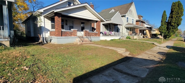 view of front of property with a porch and a front lawn