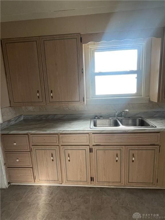 kitchen featuring light brown cabinetry and sink