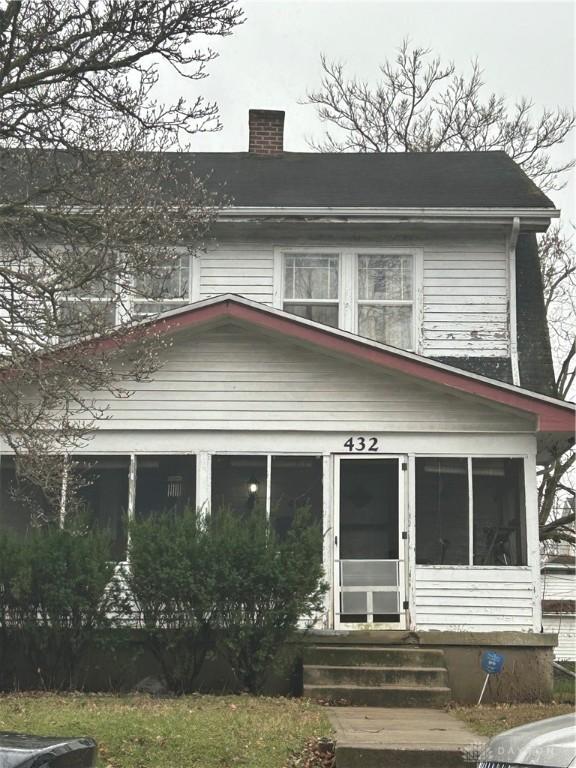 view of front of home with a sunroom