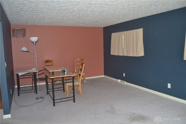 dining space featuring carpet, a textured ceiling, and vaulted ceiling