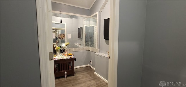 bathroom with crown molding and hardwood / wood-style flooring