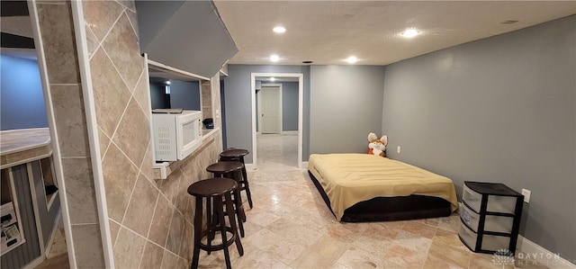 bedroom featuring tile walls