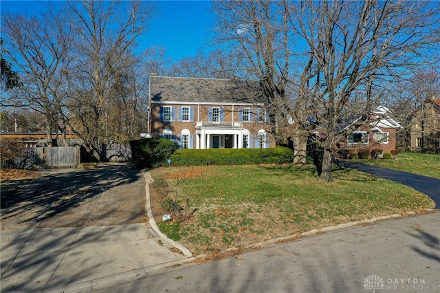 colonial inspired home with a front yard