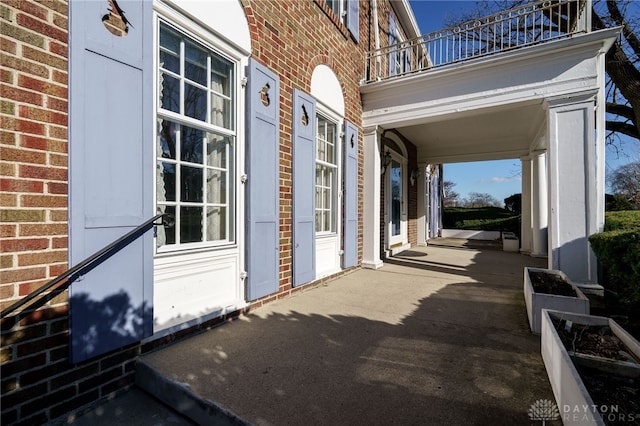 view of patio featuring a balcony