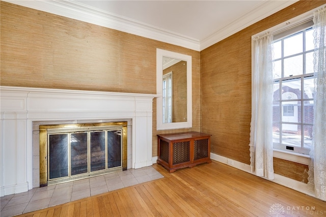 unfurnished living room with a fireplace, light hardwood / wood-style flooring, and ornamental molding