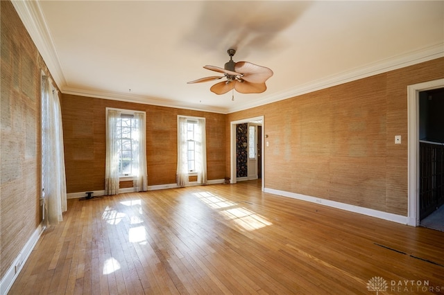 unfurnished room with ceiling fan, ornamental molding, and hardwood / wood-style flooring