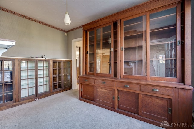 interior space with light colored carpet and ornamental molding