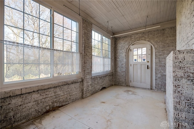 unfurnished sunroom featuring wooden ceiling