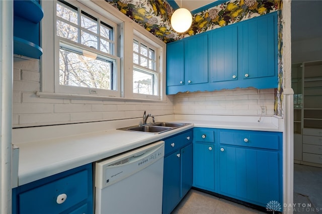 kitchen featuring dishwasher, blue cabinets, and sink