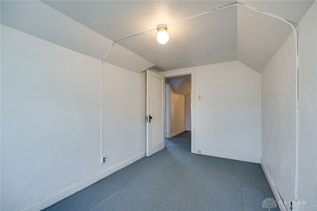 additional living space with carpet floors and vaulted ceiling