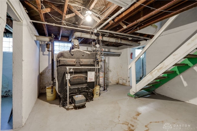 basement featuring a wealth of natural light and water heater