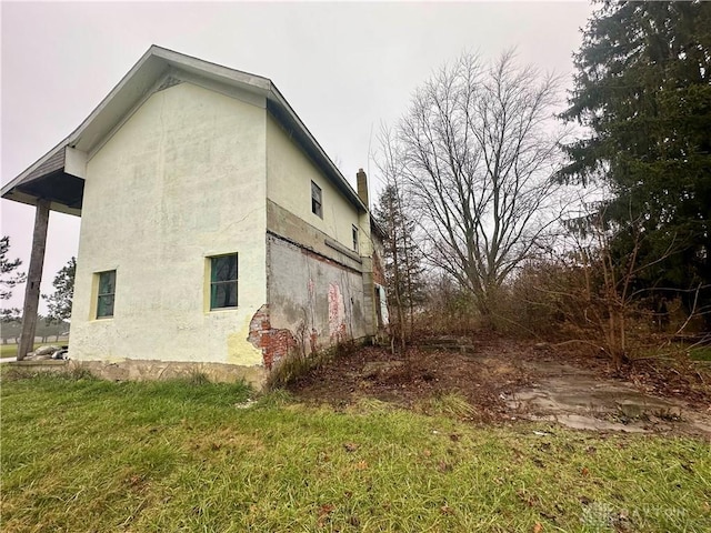 view of property exterior featuring a lawn