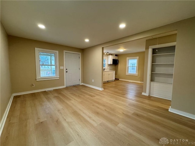 unfurnished living room with light hardwood / wood-style flooring