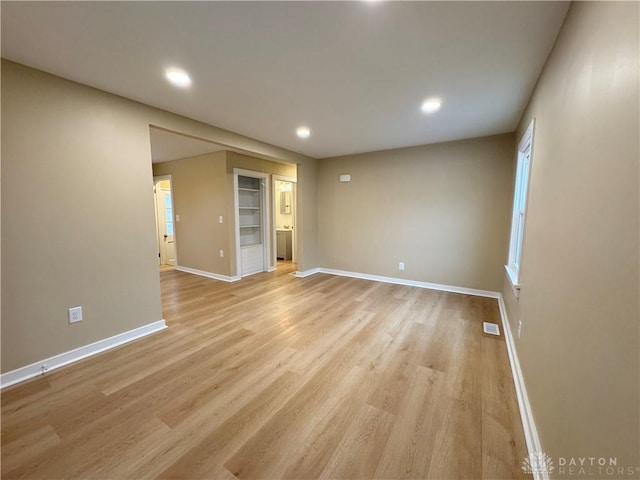 unfurnished room with light hardwood / wood-style floors