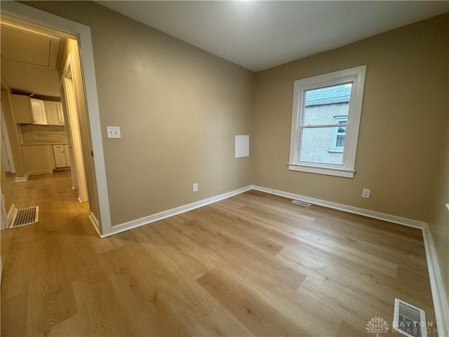 spare room with light hardwood / wood-style floors