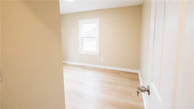 spare room with light hardwood / wood-style flooring