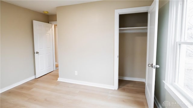 unfurnished bedroom featuring a closet and light hardwood / wood-style flooring