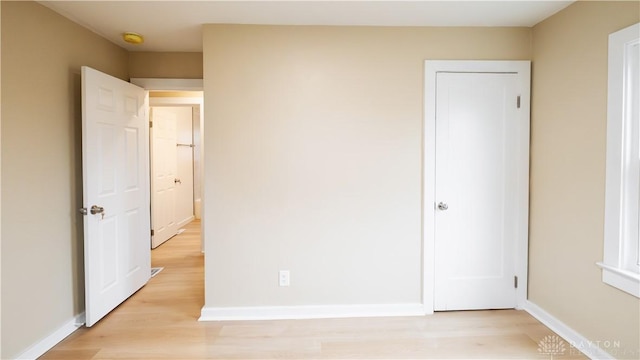 unfurnished bedroom with light wood-type flooring