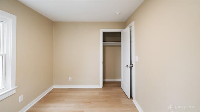 unfurnished bedroom featuring a closet and light hardwood / wood-style flooring