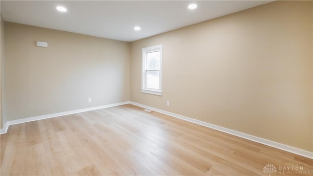 unfurnished room with light hardwood / wood-style flooring