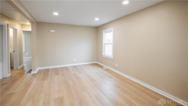 spare room featuring light hardwood / wood-style flooring