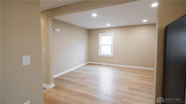 spare room featuring light hardwood / wood-style flooring