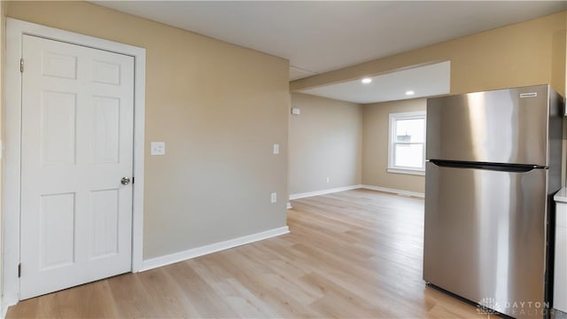 kitchen featuring stainless steel fridge and light wood-type flooring